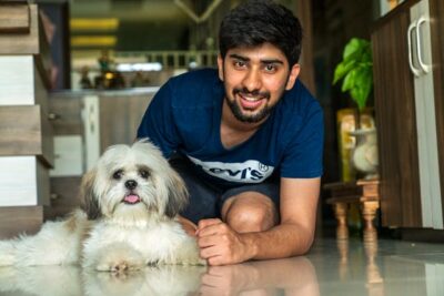 Man beside his Shih Tzu Dog